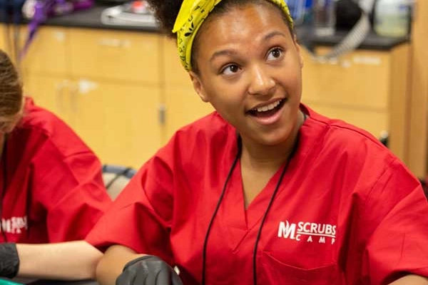 Scrubs camp participant doing labs
