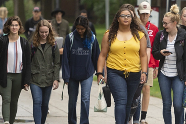 Group of students walking on the sidewalk