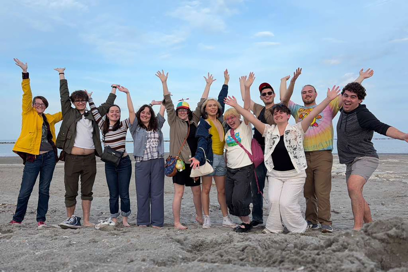 Art students jumping on beach in Italy