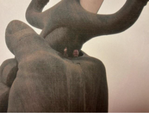 Aaron inside the hands of the cross sabers of a statue