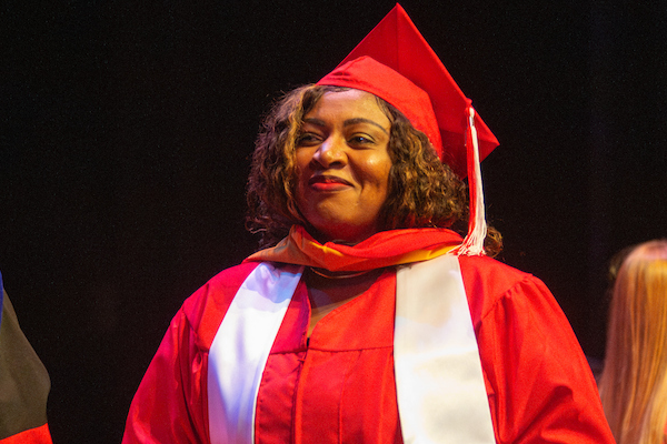 Graduate student receiving diploma sleeve