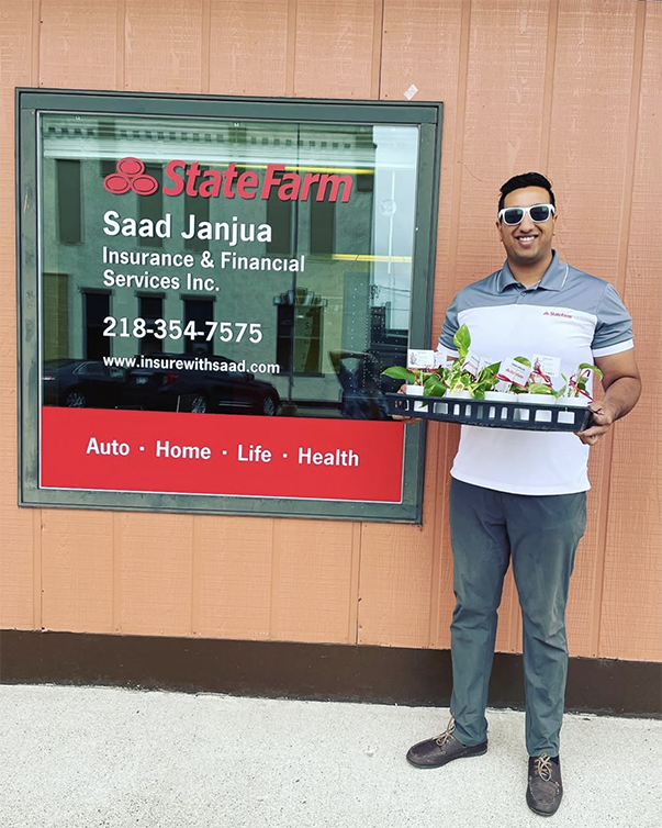 Saad Janjua in front of business window