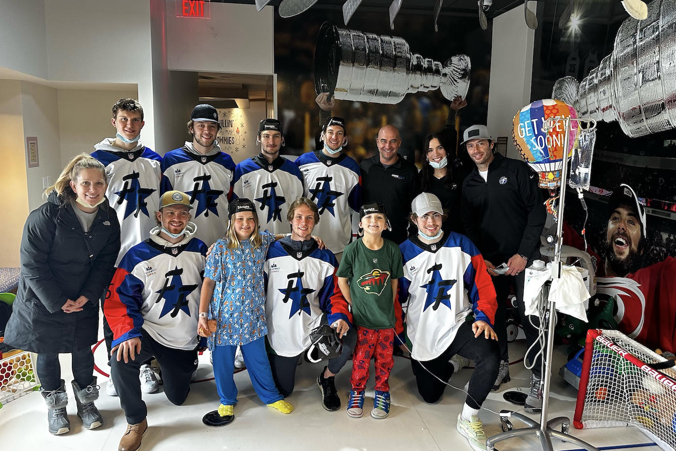 Katie with Fargo Force players at Sanford Children's Hospital