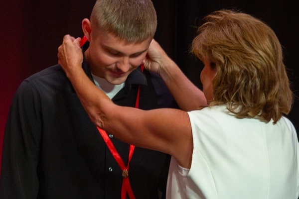 Nursing student receiving pin from advisor