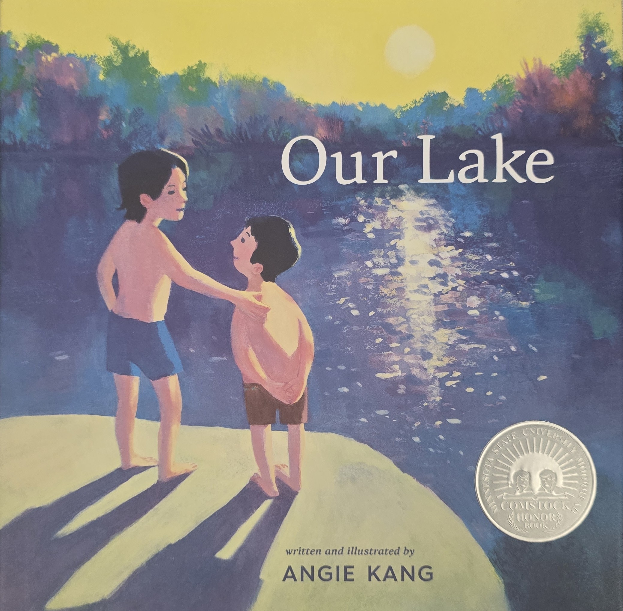 Our Lake book cover with two boys standing on a dock at sunset