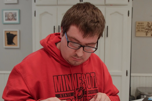 Student in red sweatshirt studying
