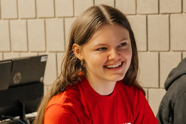 Student smiling with red shirt on